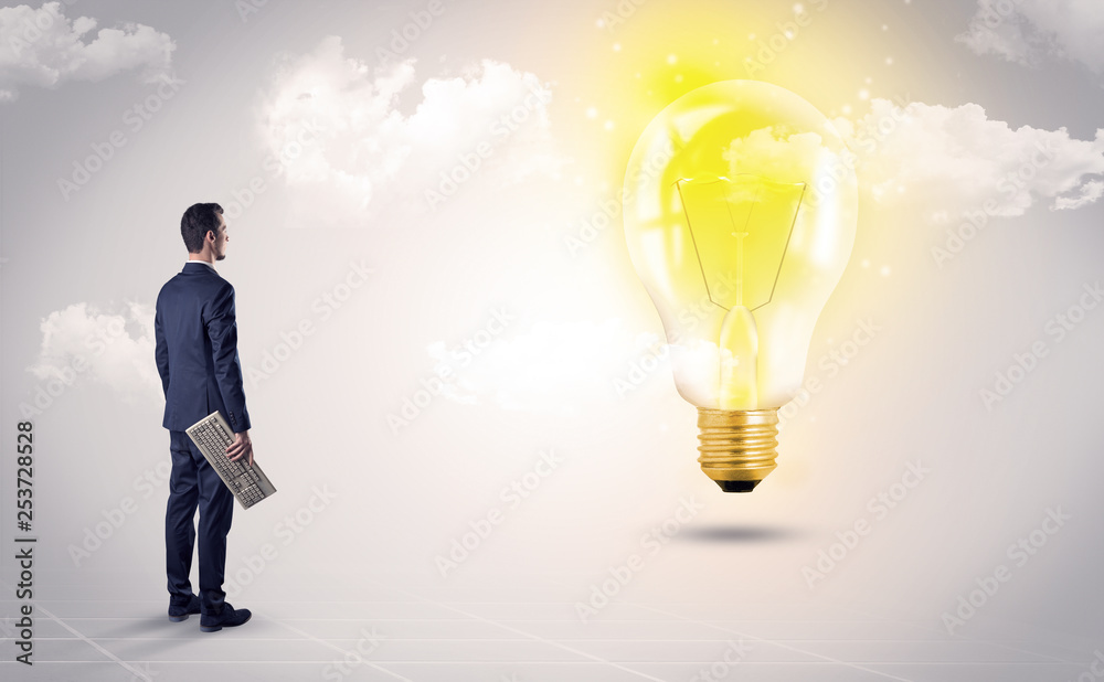 Fototapeta premium Businessman standing with his back with objects in his hand and looking at the globe, courtesy of NASA 
