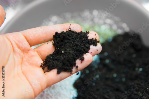 Soil in the hands of a man. Close up. Soil growing cannabis. A mixture of earth, perlite and vermiculite. The concept of growing medical cannabis in the doore indoor. Substrate for marijuana. photo