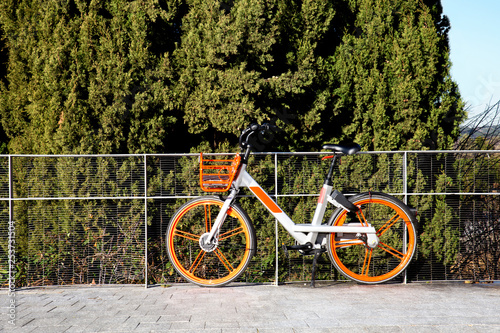 orange urban bicycle for rent in madrid city