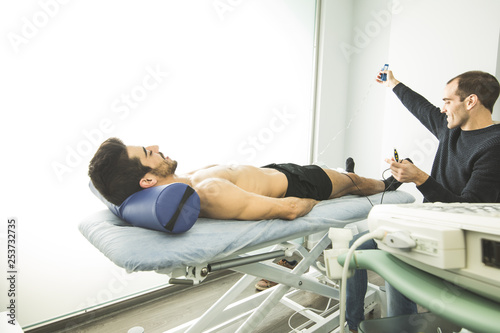 Physiotherapist examining a patient with an ultrasound scan. Concept of advanced elbow physiotherapy