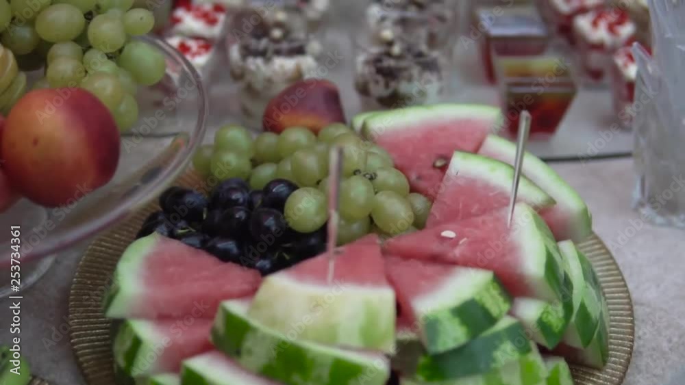 A quick review of fruit and sweets on the wedding glass table A quick review of fruit and sweets on the wedding glass table