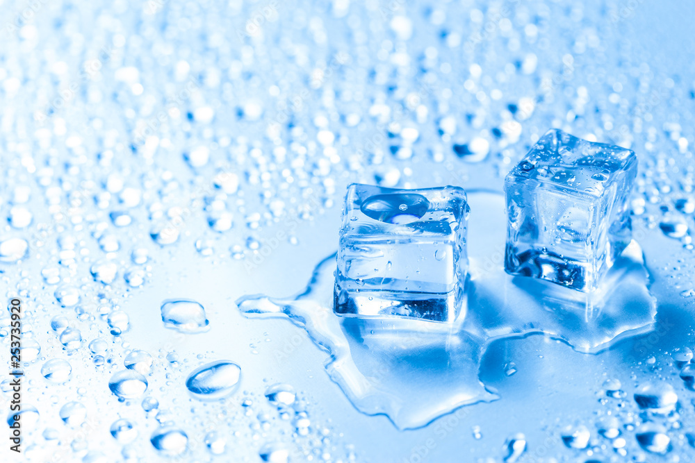 Two melted ice cubes with water drops Two melted ice cubes with water drops