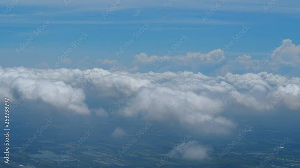 Above the clouds, flying in the air. View of clouds through airplane window. Above the clouds, flying in the air. View of clouds through airplane window.