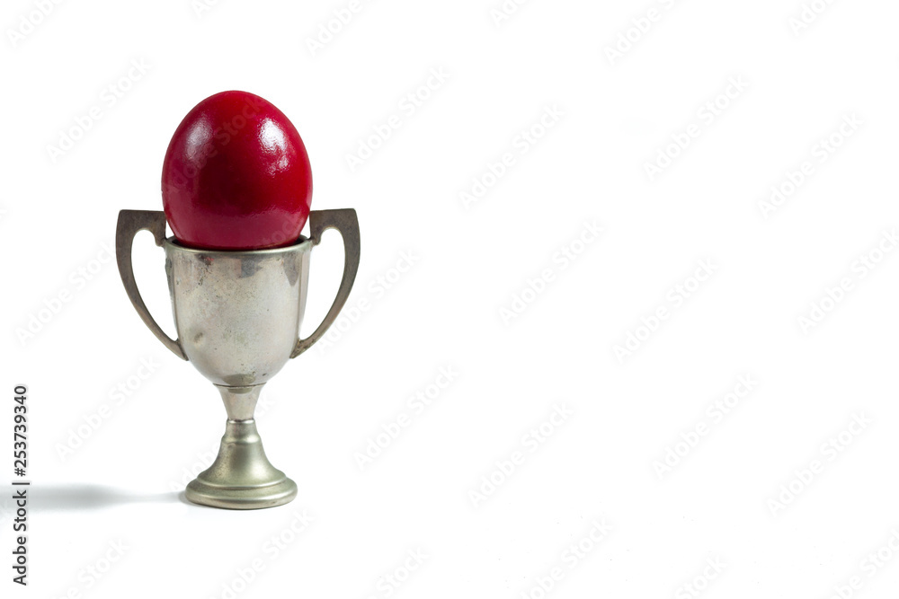 red egg in a silver cup isolated on white red egg in a silver cup isolated on white