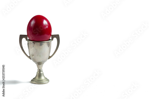 red egg in a silver cup isolated on white