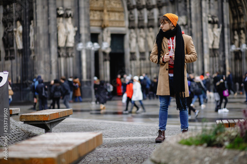 Casual style. Man stands against the sights. Cathedral Church of Saint Peter. Cologne Cathedral. Germany. Gothic architecture. 