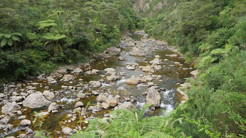 high angle static view over pristine clear waitawheta river stream in New Zealand photo