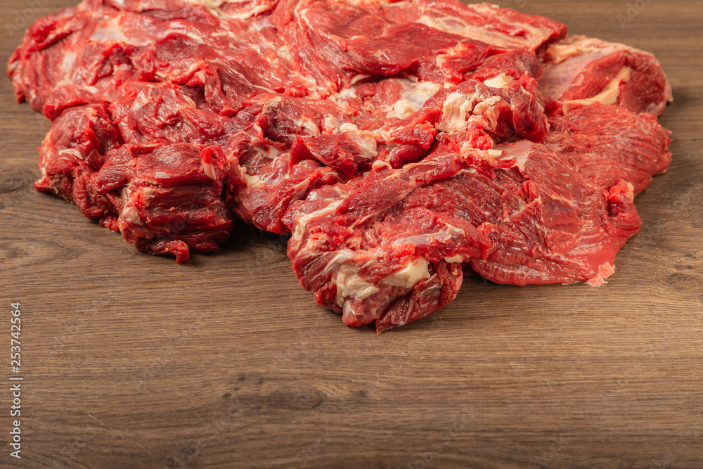 Raw fresh beef on a wooden background, catalog. Raw fresh beef on a wooden background, catalog.