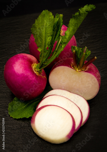 close-up of a red turnip sliced over a black background