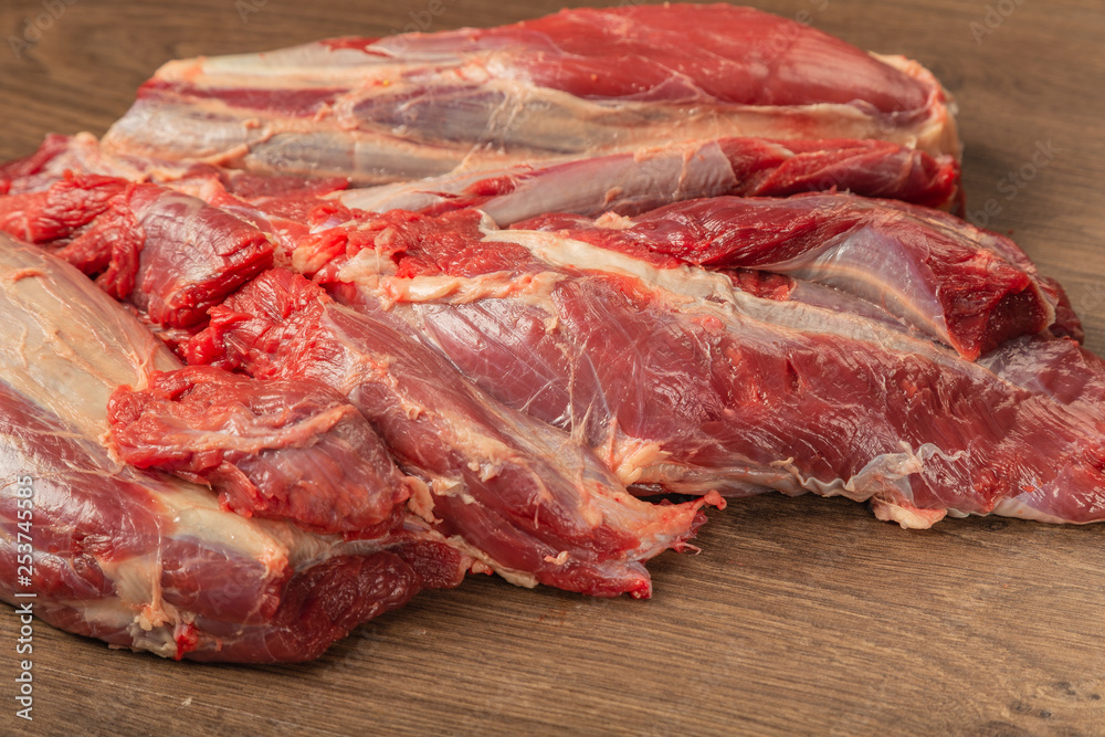 Raw fresh beef on a wooden background, catalog.