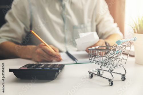 cost of living concept - man calculating bills of household daily expenses