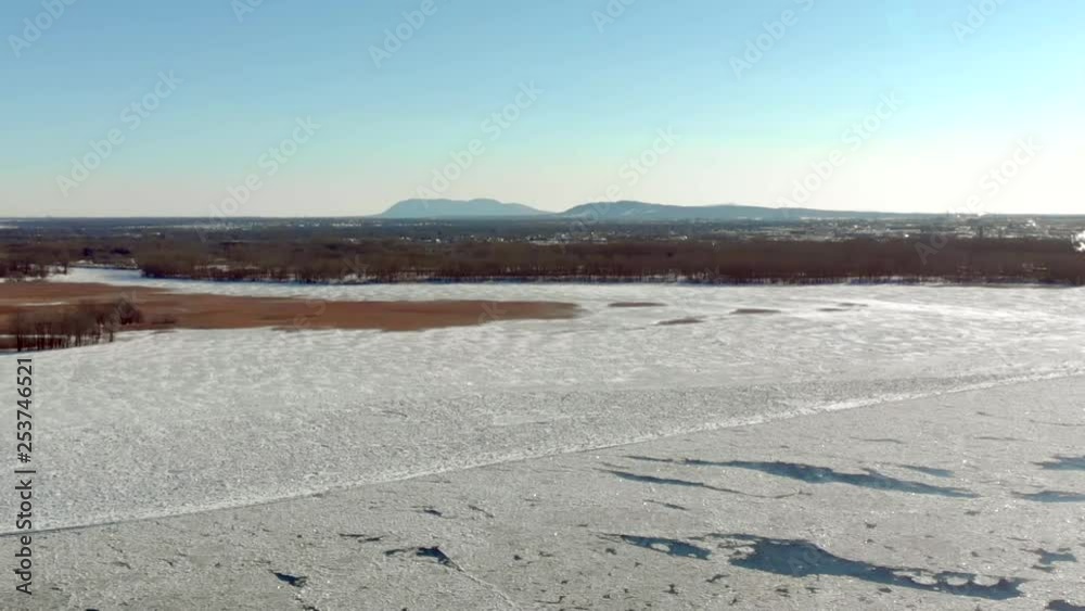 Aerial view of frozen river moving at the end of winter slow motion Aerial view of frozen river moving at the end of winter slow motion