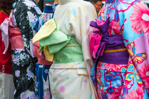 Japanese women wearing traditional Kimono walk on the streets of Kyoto, Japan.
