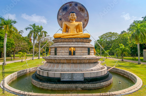 Beautiful landscape and golden buddha statue in Viharamahadevi Park, Colombo, Sri Lanka. photo