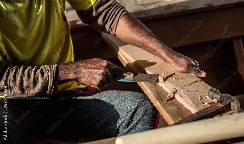 hands working on piece of wood to get it into right shape hands working on piece of wood to get it into right shape