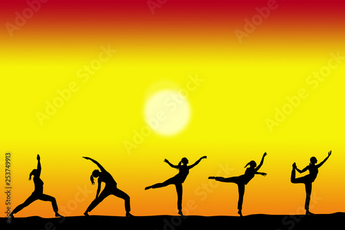 group of yoga female silhouettes with a sunset on the background and copy space for your text