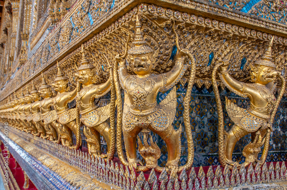 Garudas and nagas on external decorations of the Ubosoth, Wat Phra Kaew temple, Grand Palace, Bangkok, Thailand.