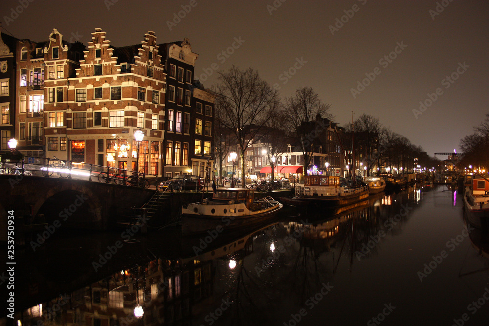 Obraz premium famous bridge in amsterdam. romantic night landscape. a bit of haze and fog makes the magic channel
