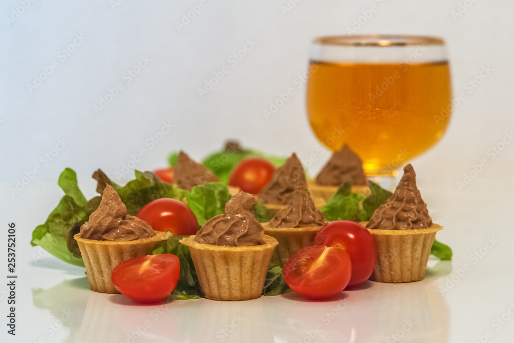 tartlets with liver pate decorated with lettuce and cherry tomatoes