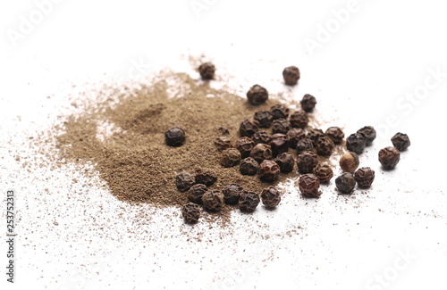 Black pepper grains and powder isolated on white background