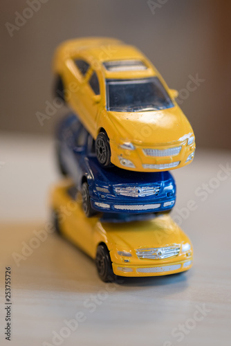 three toy cars in yellow and blue