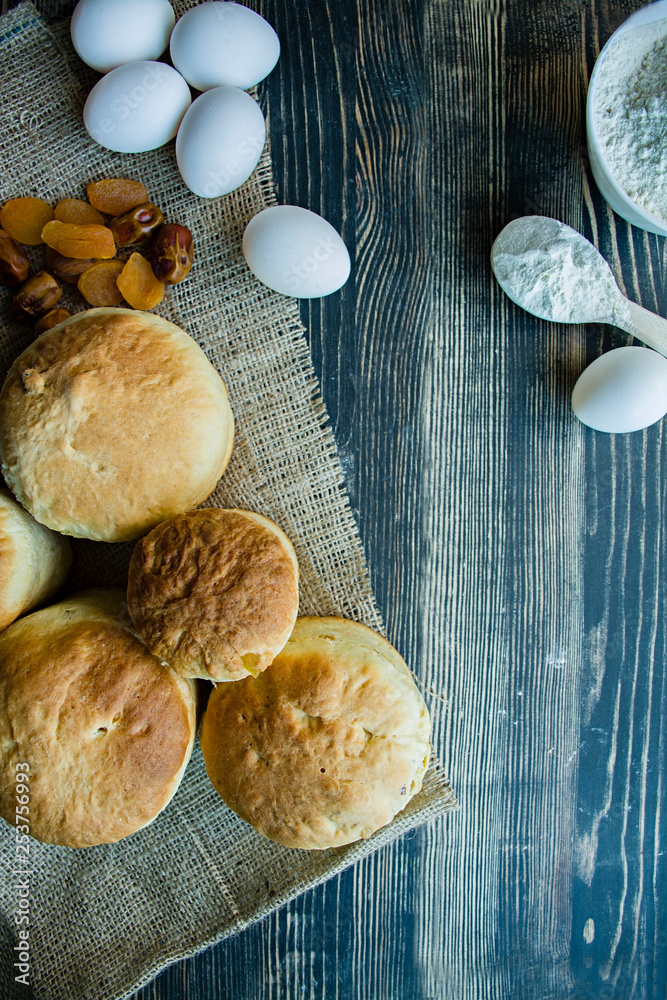 Easter cake on a dark background. Fresh cakes with dried fruits. The process of making Easter cakes. View from above. Easter cake on a dark background. Fresh cakes with dried fruits. The process of making Easter cakes. View from above.
