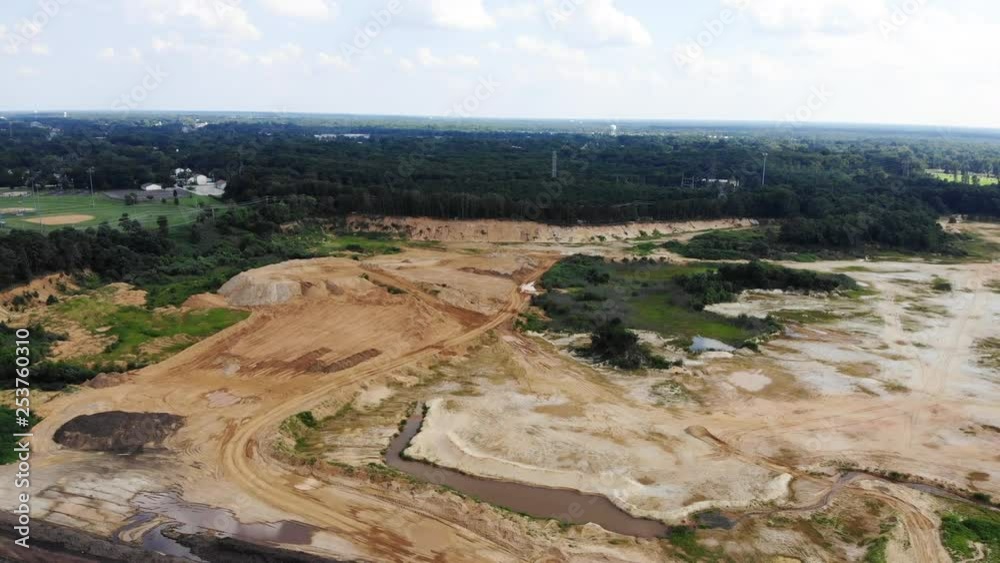 Big gravel plant with water surrounded by nature and trees. Great view over the landscape and the gravel plant. Big gravel plant with water surrounded by nature and trees. Great view over the landscape and the gravel plant.