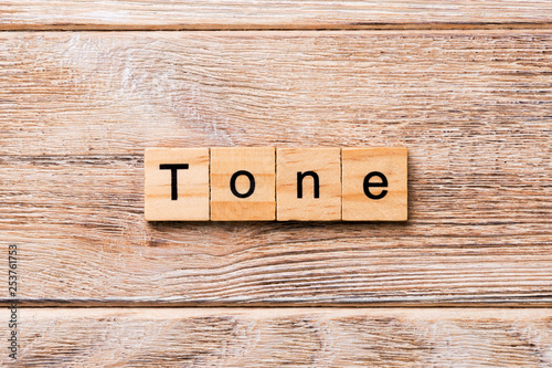 tone word written on wood block. tone text on wooden table for your desing, concept