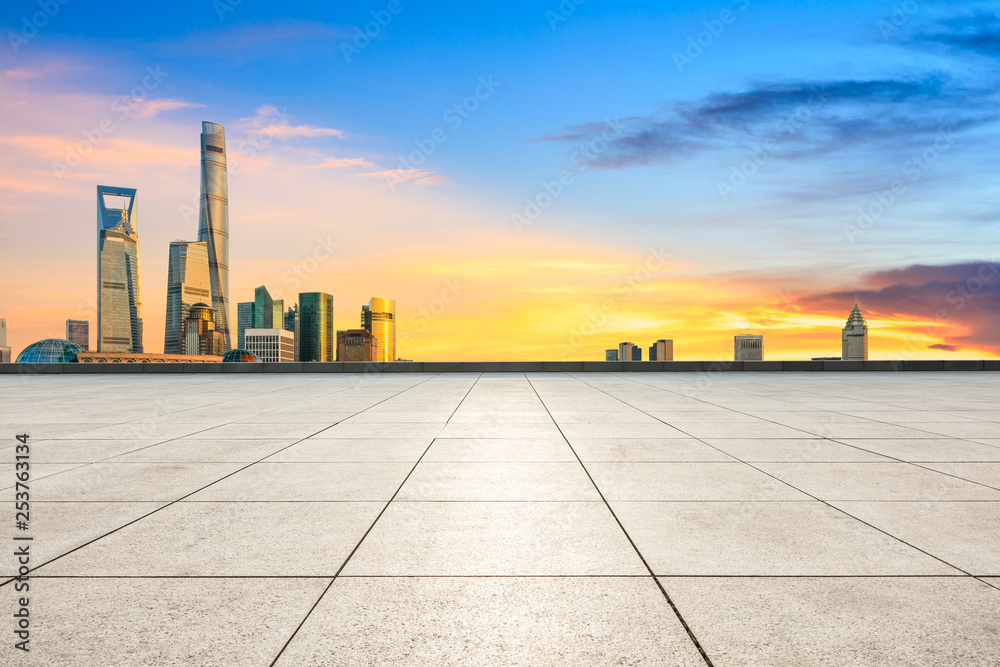 Empty square floor and modern city buildings in Shanghai at dusk