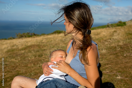 Mother breastfeeding her toddler son on the top of hill in Exmoor National Park photo