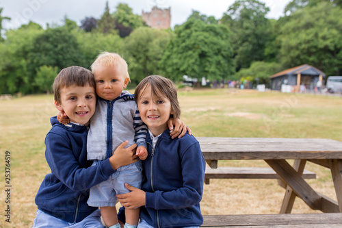Beautiful children on alawn in front of the Dunston Castle in England
