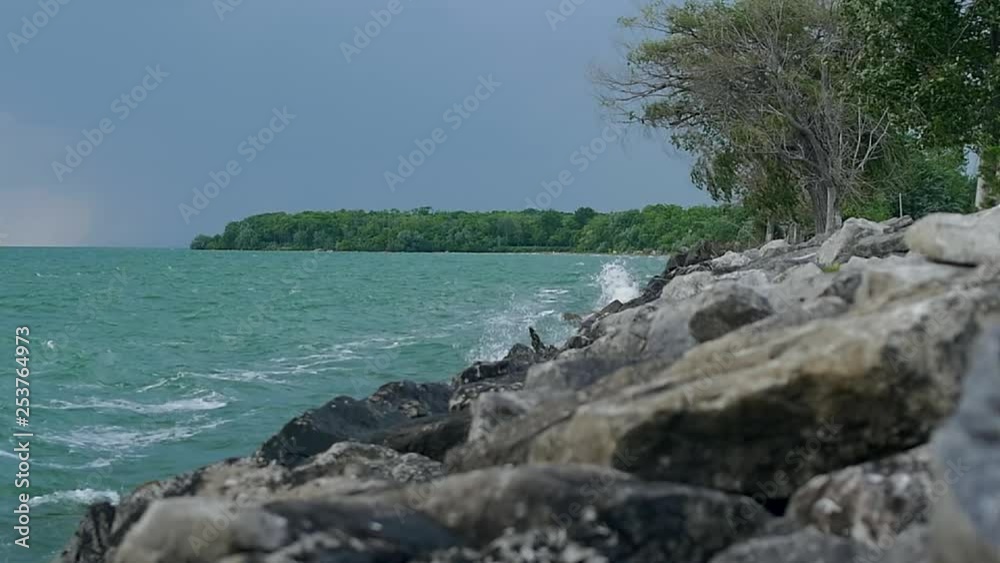 slow motion view of the blue sea with big waves hitting the coast line still shot slow motion view of the blue sea with big waves hitting the coast line still shot