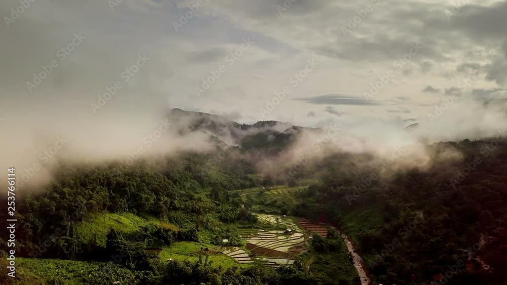Aerial view flying above lush green tropical rain forest mountain with rain cloud cover during the rainy season on the Doi Phuka Mountain reserved national park the northern Thailand Aerial view flying above lush green tropical rain forest mountain with rain cloud cover during the rainy season on the Doi Phuka Mountain reserved national park the northern Thailand