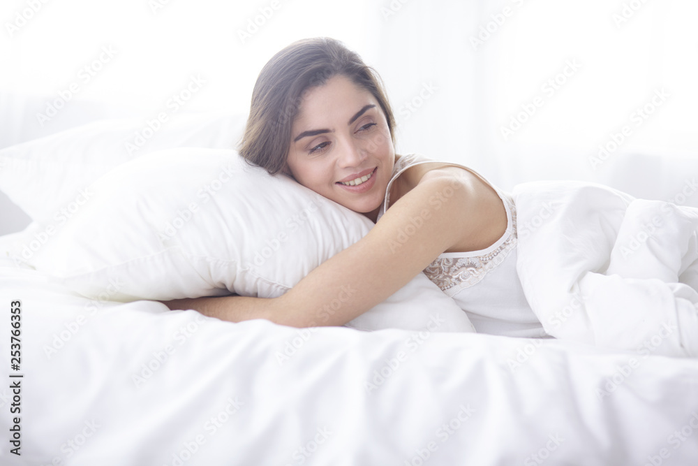 beautiful young woman basking in bed in the morning. Beautiful Model face looks sexy in camera beautiful young woman basking in bed in the morning. Beautiful Model face looks sexy in camera