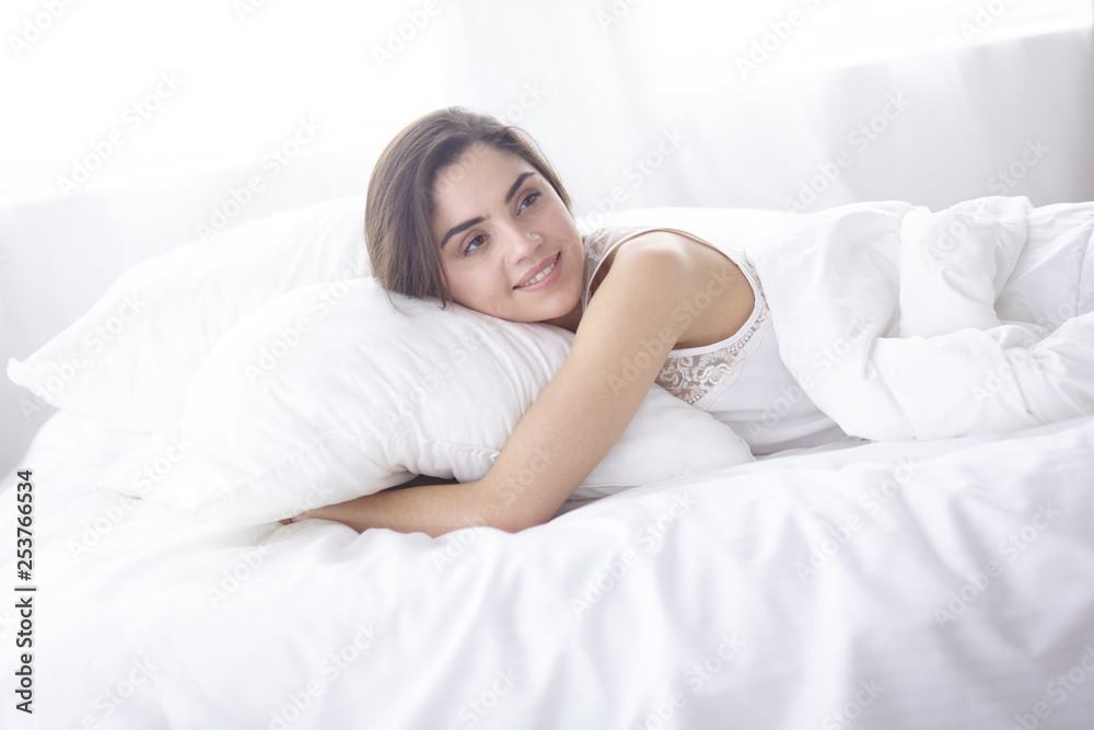 beautiful young woman basking in bed in the morning. Beautiful Model face looks sexy in camera beautiful young woman basking in bed in the morning. Beautiful Model face looks sexy in camera