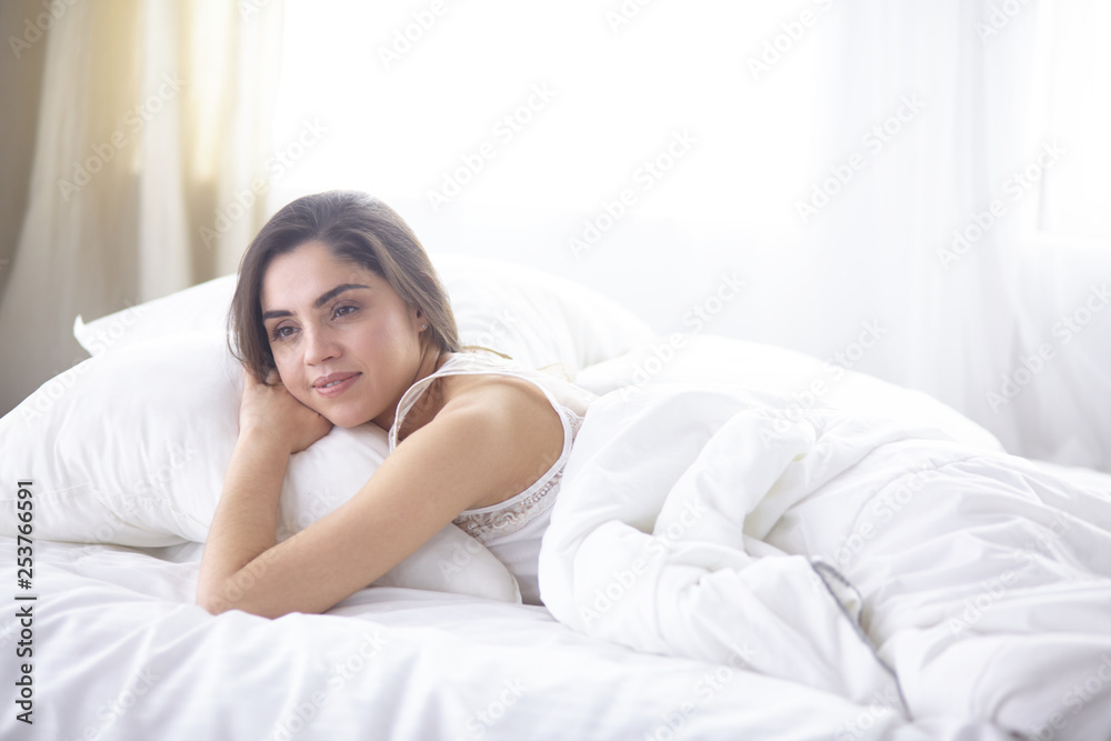 beautiful young woman basking in bed in the morning. Beautiful Model face looks sexy in camera beautiful young woman basking in bed in the morning. Beautiful Model face looks sexy in camera