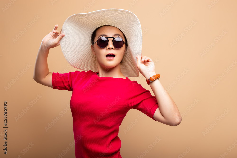 Portrait woman wearing big hat isolated on brown beige background