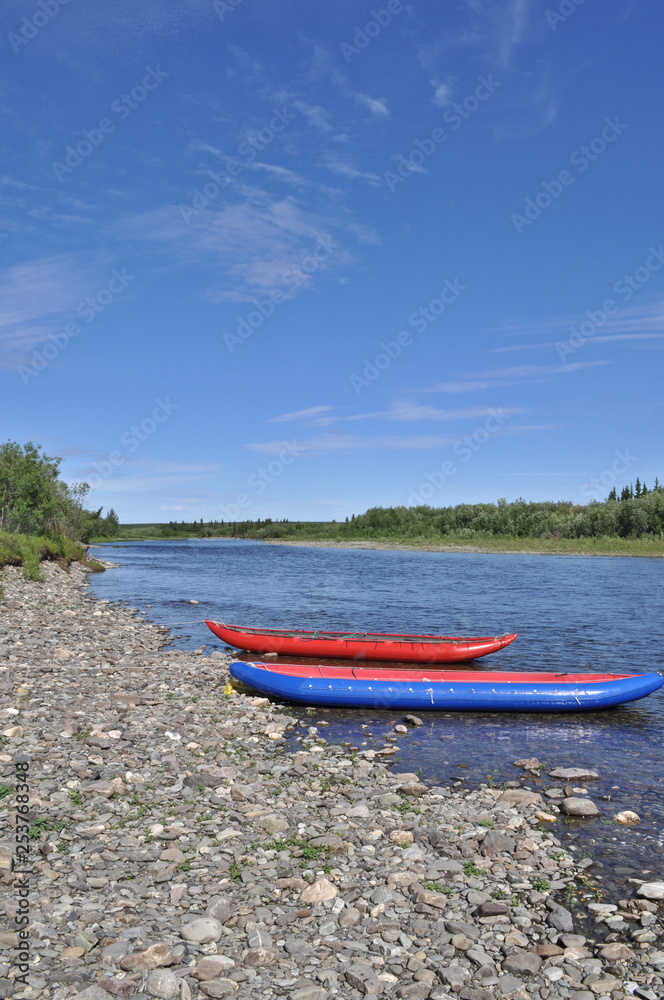 Two inflatable canoes on the shore of  North river.