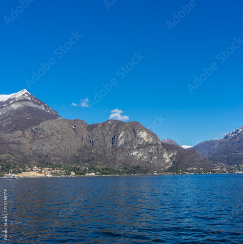 Italy, Bellagio, Lake Como, Cadenabbia, SCENIC VIEW OF SEA AND MOUNTAINS AGAINST CLEAR BLUE SKY