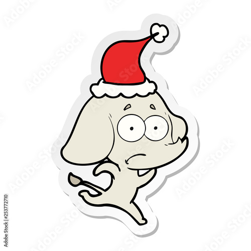 sticker cartoon of a unsure elephant running away wearing santa hat