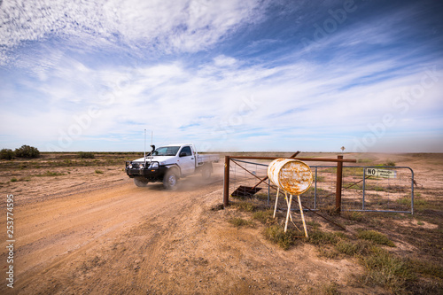 A farmer drives out of a large farm property in outback New South Wales. photo