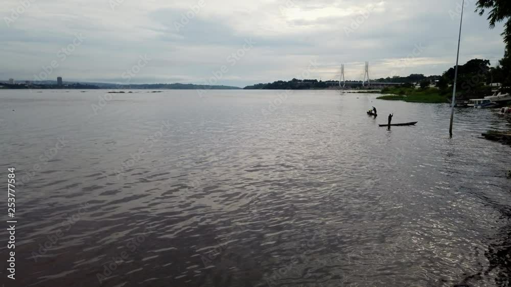 Fishermen and skyline of the Congo river, the bridge of August 15, 1960 and the Democratic Republic of Congo Fishermen and skyline of the Congo river, the bridge of August 15, 1960 and the Democratic Republic of Congo