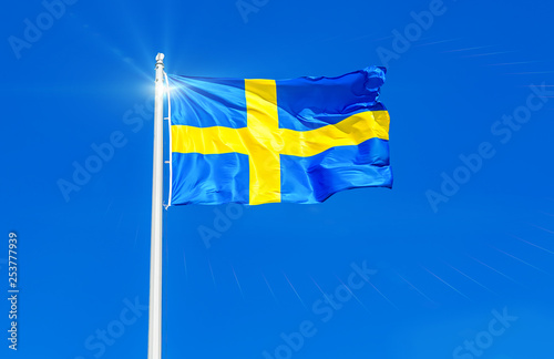 Fotografie Flag of Sweden flying in the wind against the sky