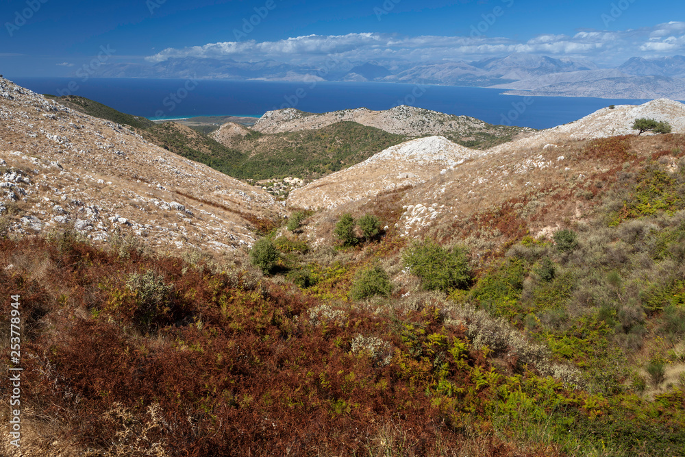 Aerial view over mountains to the rural road and Ionian sea, Pantokrator mountain foothill, Corfu, Greece