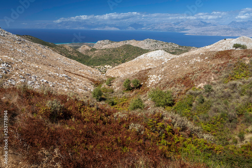 Aerial view over mountains to the rural road and Ionian sea, Pantokrator mountain foothill, Corfu, Greece