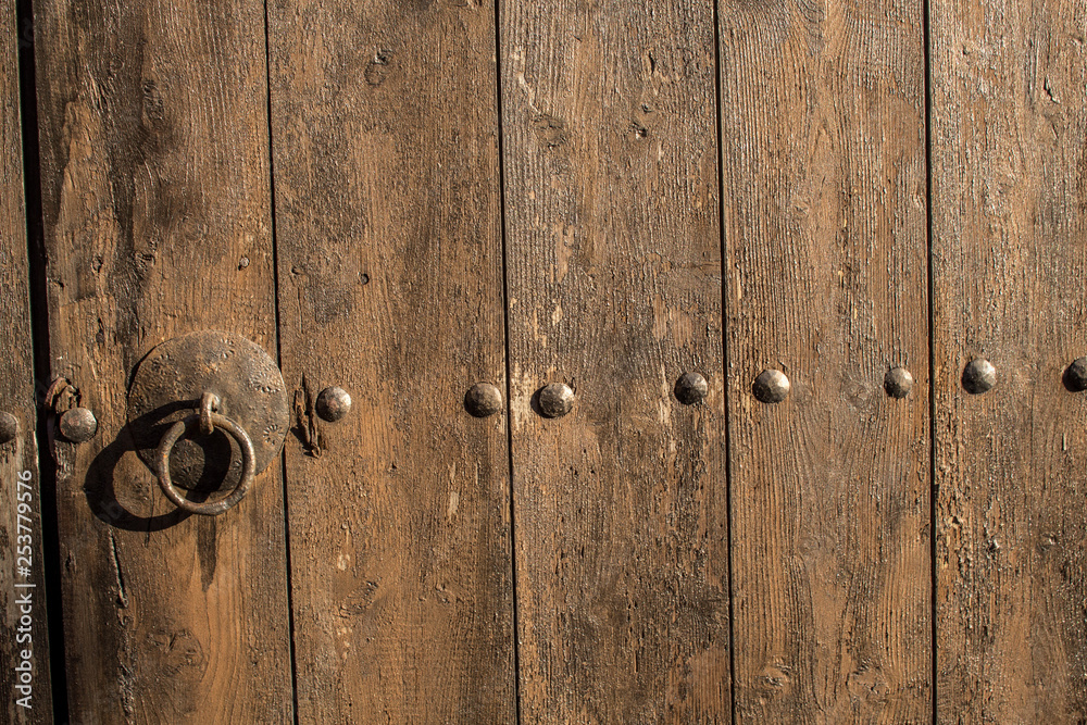 Part of old antique wooden gate with rusty metal door ring Part of old antique wooden gate with rusty metal door ring