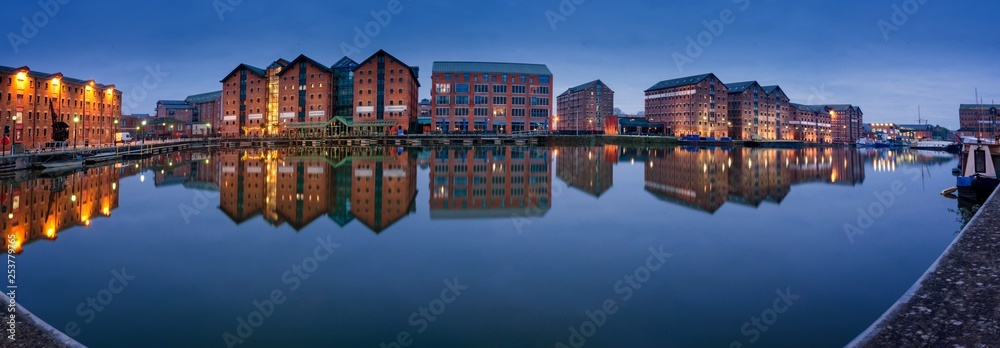 Fototapeta premium Gloucester docks warehouses reflected in quay on Sharpness Cana