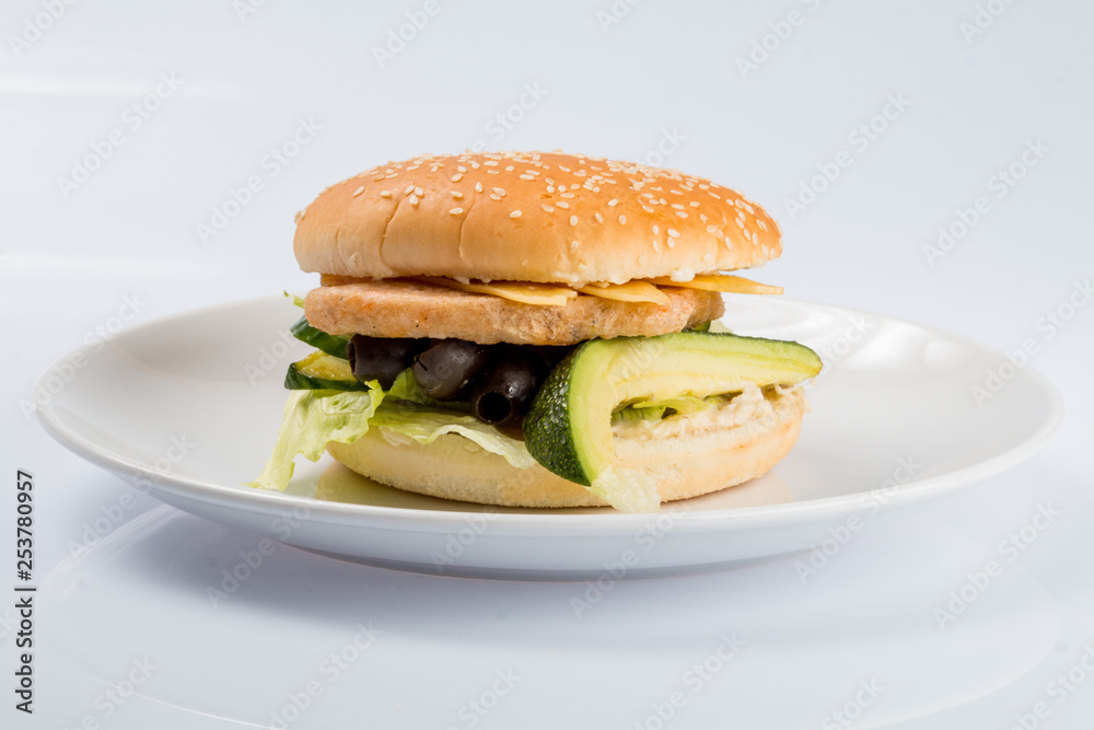cheeseburger with beef cutlet, bacon, tomatoes and cheese slices, seasoned with sauce and green salad for a restaurant menu on a white isolated background cheeseburger with beef cutlet, bacon, tomatoes and cheese slices, seasoned with sauce and green salad for a restaurant menu on a white isolated background