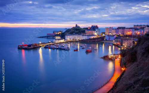 Tenby harbour, wales just before sunrise, Boats and buildings in blue hour.