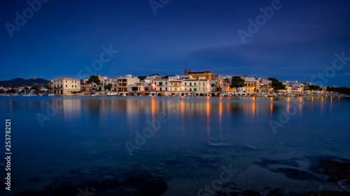Porto Colom, mallorca, town reflecting in calm Mediterranean sea